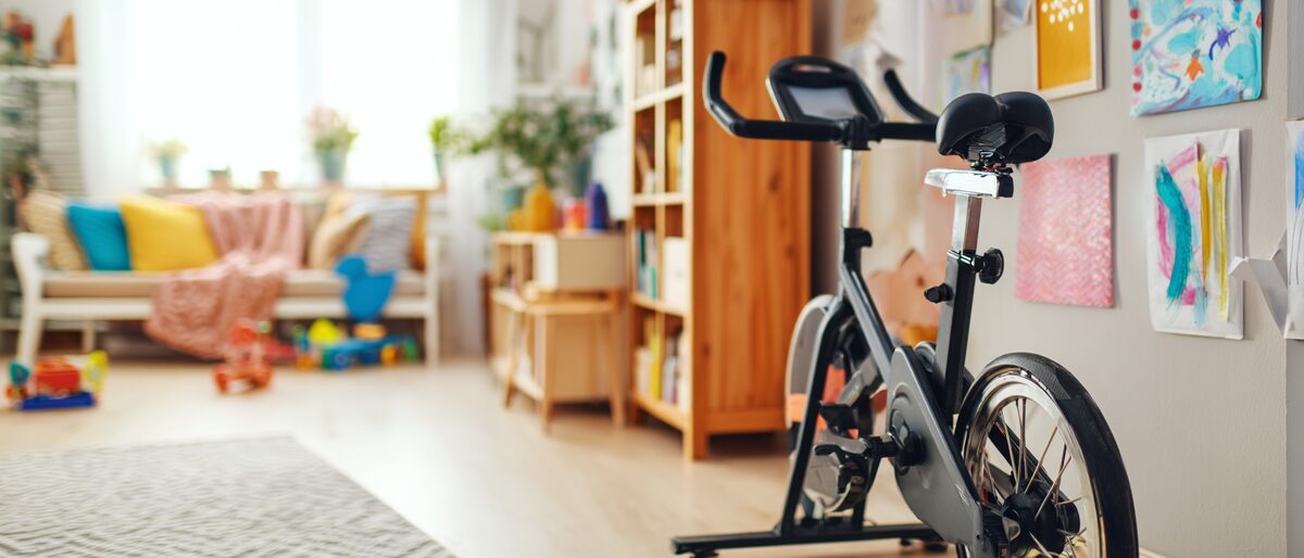 Exercise bike - picture of an exercise bike in a room used for mixed purposes - i.e. a childens play area and exercise area for all the family